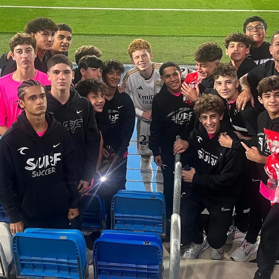 Jeremy de León, al centro, comparte con jóvenes boricuas tras el partido entre el Real Madrid Castilla y el Castellón el sábado.