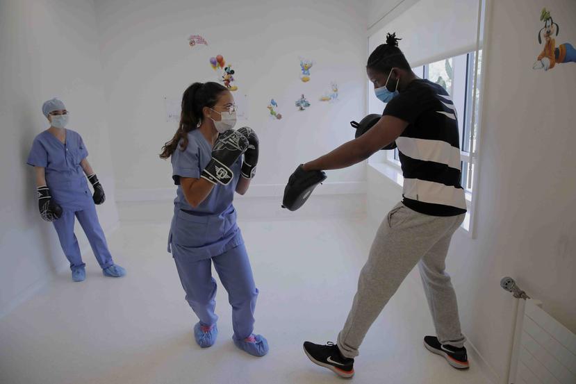 La enfermera Kenza Benour practica con el excampeón mundial de boxeo Hassan N'Dam en el hospital Villeneuve -Saint-Georges de las afueras de París. (AP)