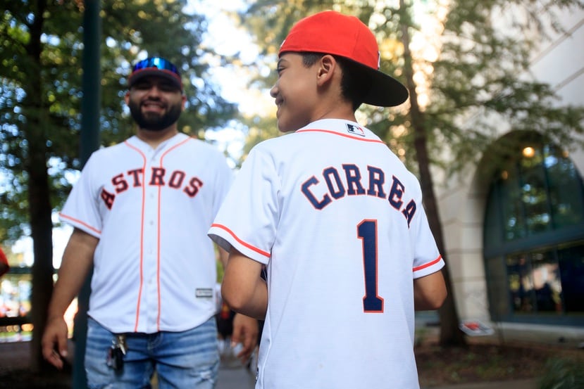 Un niño muestra su camiseta de Carlos Correa.