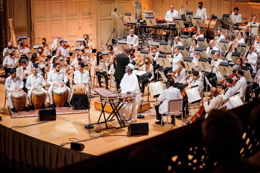 Los músicos de la Boston Pops Orchestra en la sala de conciertos Boston Symphony Hall y los músicos puertorriqueños, junto balafonista de Mali, Balla Kouyate y la dirección del maestro Keith Lockhart.
