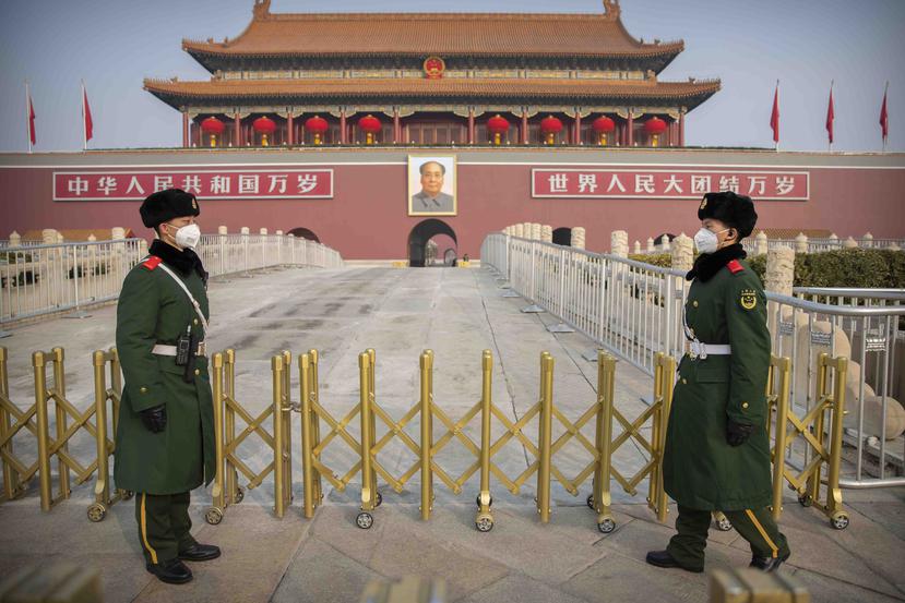 Dos guardias con máscaras sanitarias vigilan en la Plaza Tiananmen, en Beijing, China. (AP/Mark Schiefelbein)