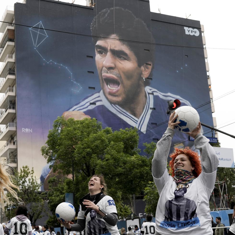 Un grupo de mujeres juegan con balones durante la inauguración del mural de Diego Maradona del artista Martín Ron en Buenos Aires.