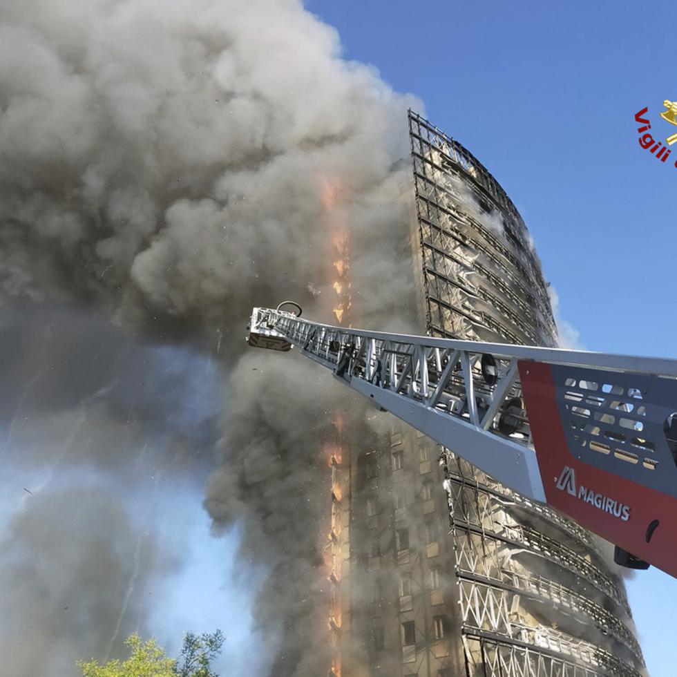 Bomberos intentan controlar el fuego en el condominio en Milán, Italia.