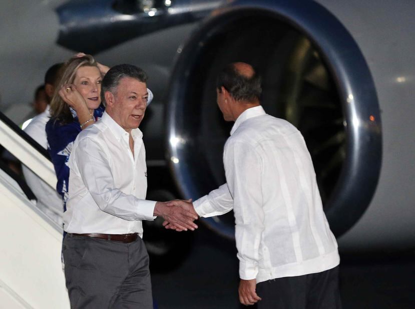 El presidente de Colombia, Juan Manuel Santos, acompañado de su esposa, María Clemencia Rodríguez de Santos, saludan al viceministro cubano de Relaciones Exteriores, Rogelio Sierra, a su llegada a Cuba. (EFE)