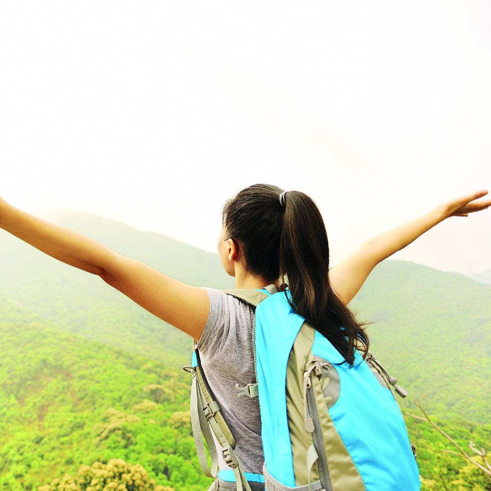 cheering hiking woman open arms at mountain peak
-----
