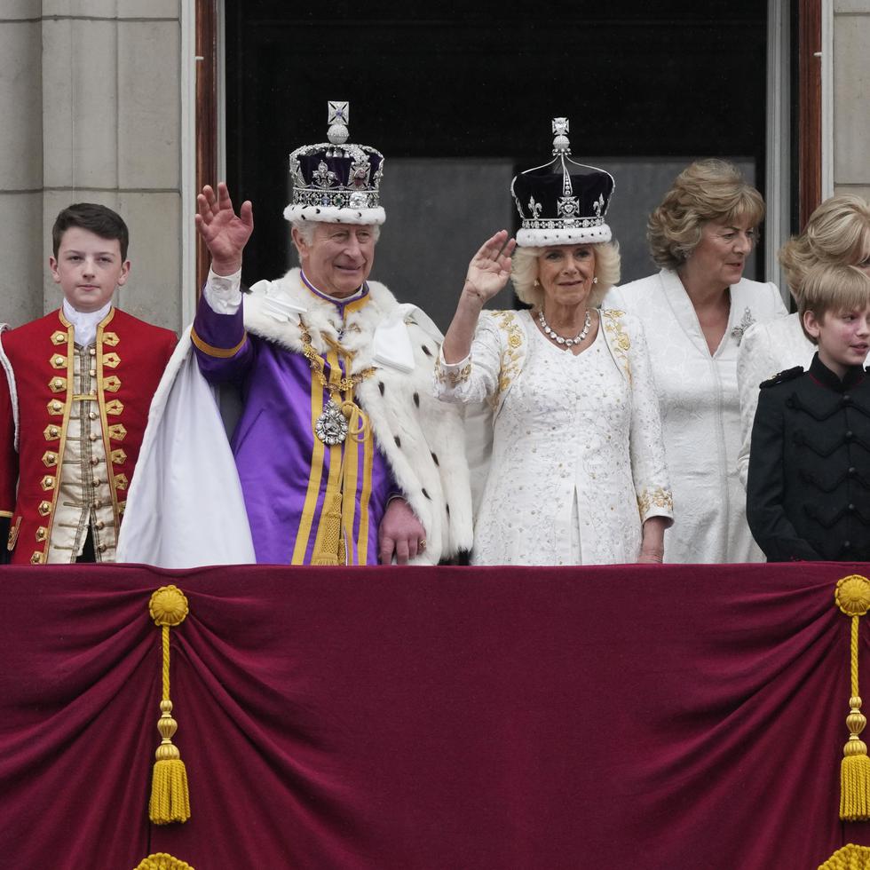 Britain's King Charles III and Queen Camilla wave to the crowds from the balcony of Buckingham Palace after the coronation ceremony in London, Saturday, May 6, 2023. (AP Photo/Frank Augstein)