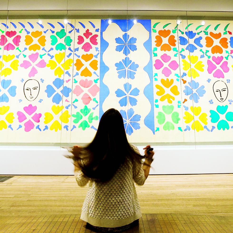 A woman adjusts her hair as she poses for photographers in front of 'Large Composition with Masks 1953' by Henri Matisse, on display during a media opportunity at The Tate Modern in London, Monday, April 14, 2014. The artwork is part of the 'Henri Matisse: The Cut-Outs' exhibition that runs at the gallery from April 17 until Sept. 7, 2014. (AP Photo/Kirsty Wigglesworth)
-----
