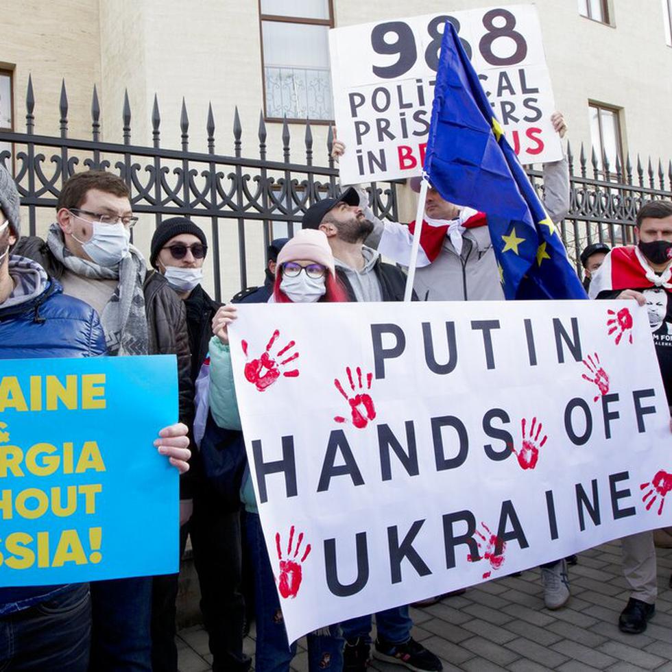Activistas georgianos sostienen carteles mientras se reúnen en apoyo a Ucrania frente a la embajada de Ucrania en Tbilisi, Georgia, el 23 de enero de 2022.