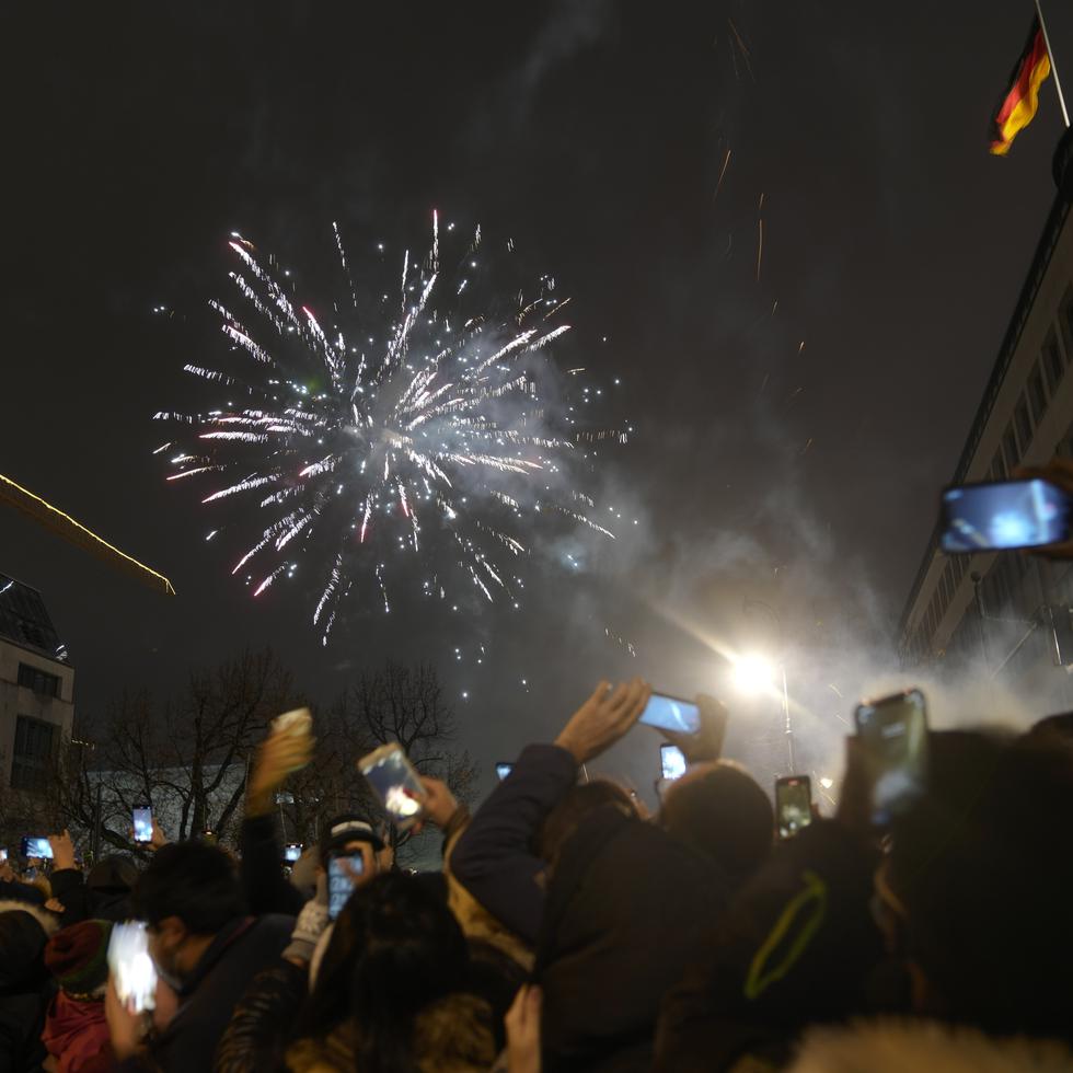 Una multitud en el boulevard Unter den Linden disfruta los fuegos artificiales por el Año Nuevo cerca de la Puerta de Brandenburgo, el 1 de enero del 2022, en Berlín.