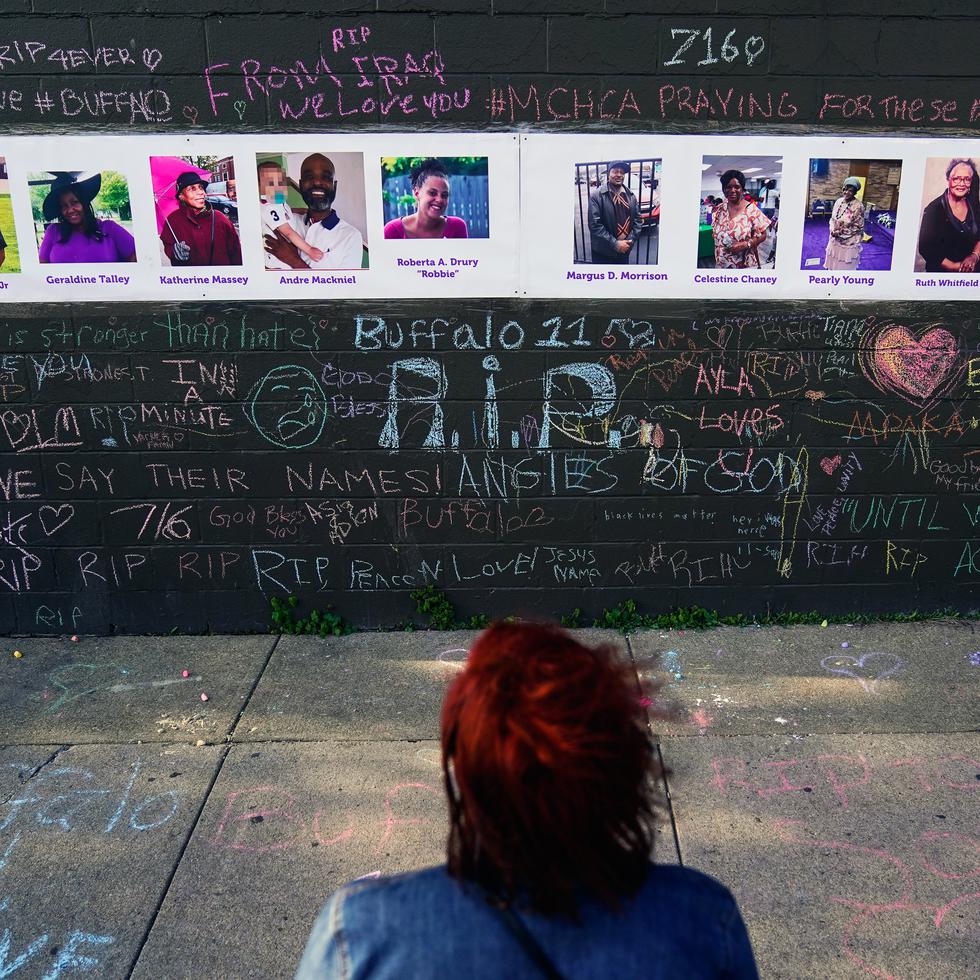 A person visits a makeshift memorial near the scene of Saturday's shooting at a supermarket, in Buffalo, Thursday, May 19, 2022. (AP Photo/Matt Rourke)
