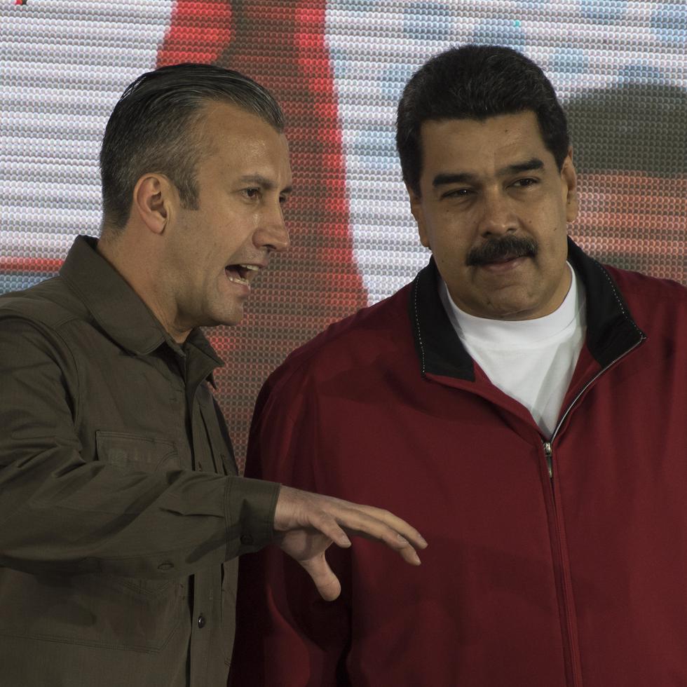 Tareck El Aissami, vice president of Venezuela, left, speaks with Nicolas Maduro, president of Venezuela, during a swearing in ceremony for the new board of directors of Petroleos de Venezuela SA (PDVSA), Venezuela's state oil company, in Caracas, Venezuela, on Tuesday, Jan. 31, 2017. Maduro has given his vice president wide-reaching decree powers, including the ability to determine ministries' spending plans and expropriate private businesses, in a move that has fueled speculation over possible succession plans. Photographer: Carlos Becerra/Bloomberg