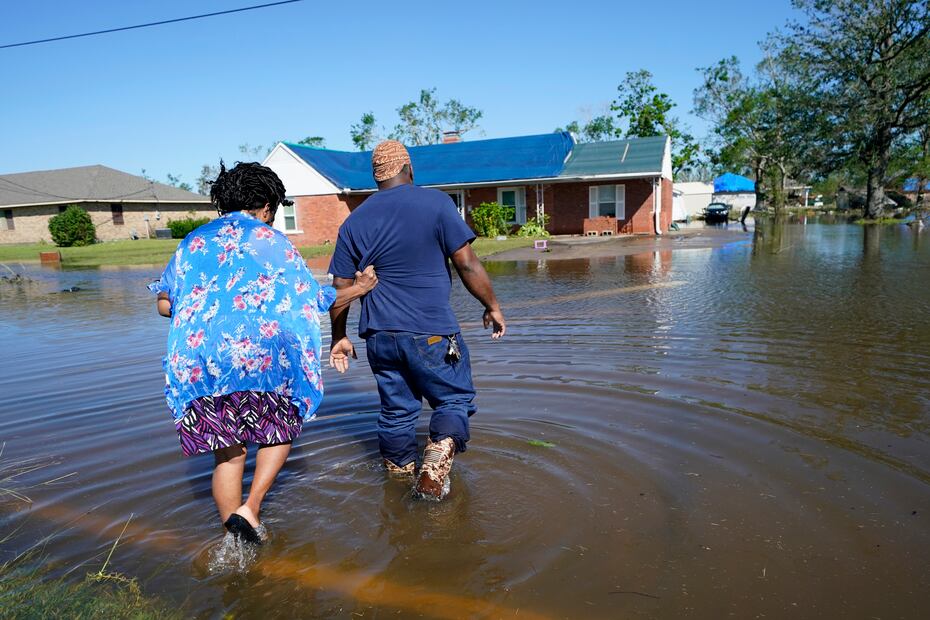 Soncia King y su esposo, Patrick King, cruzan una calle inundada para llegar hasta su residencia en Lake Charles.