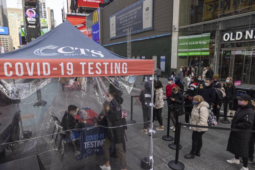 Varias personas hacen fila para que les efectúen una prueba diagnóstica de COVID-19 en un centro móvil en Times Square.