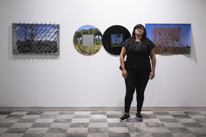 In the photo Norma Vila poses in front of her series "Structures for the impossibility of the landscape". 