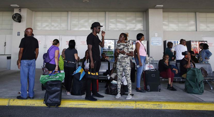 Evacuados por el huracán Dorian esperan a familiares o amigos tras ser evacuados de Freeport, en Gran Bahamas, en el crucero Grand Celebration. (AP)