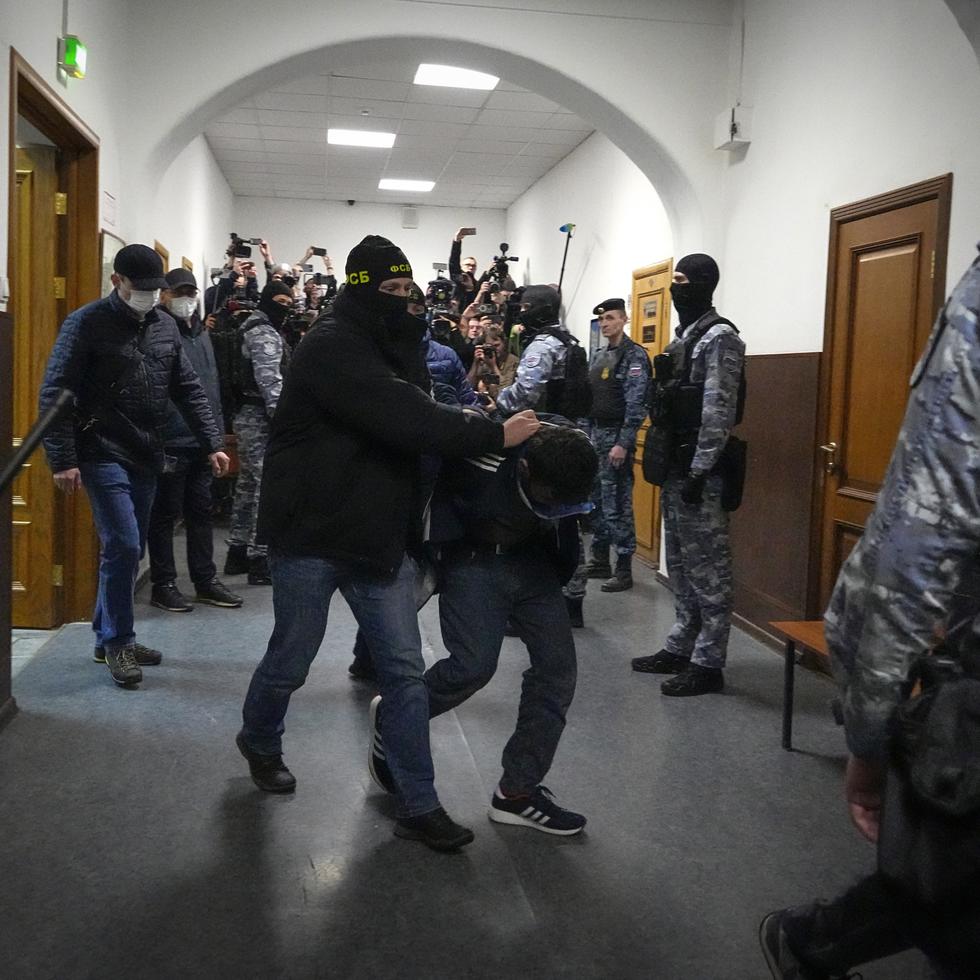 Un sospechoso de participar en el mortal ataque a un centro de conciertos en Moscú es escoltado por agentes de policía en el tribunal de Basmanny, en Moscú.