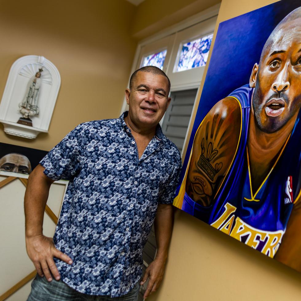 Juan Maldonado next to one of his paintings of the late basketball player Kobe Bryant.