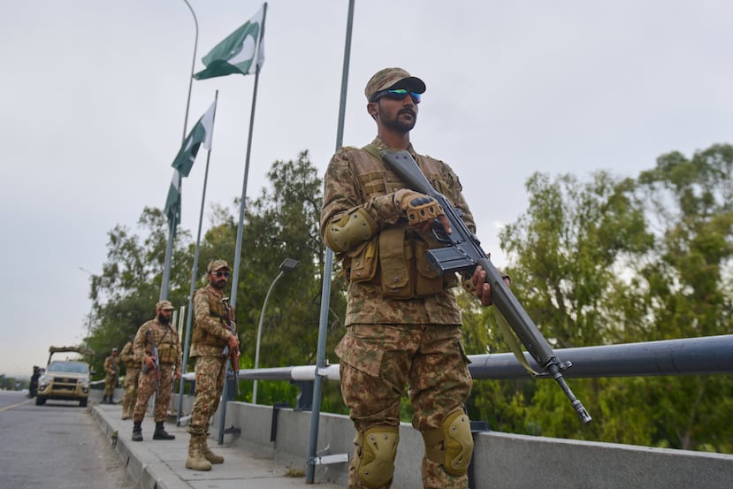 Army soldiers take positions in an overhead bridge to ensure security in Islamabad, Pakistan, Friday, April 24, 2026. (AP Photo/M.A. Sheikh)