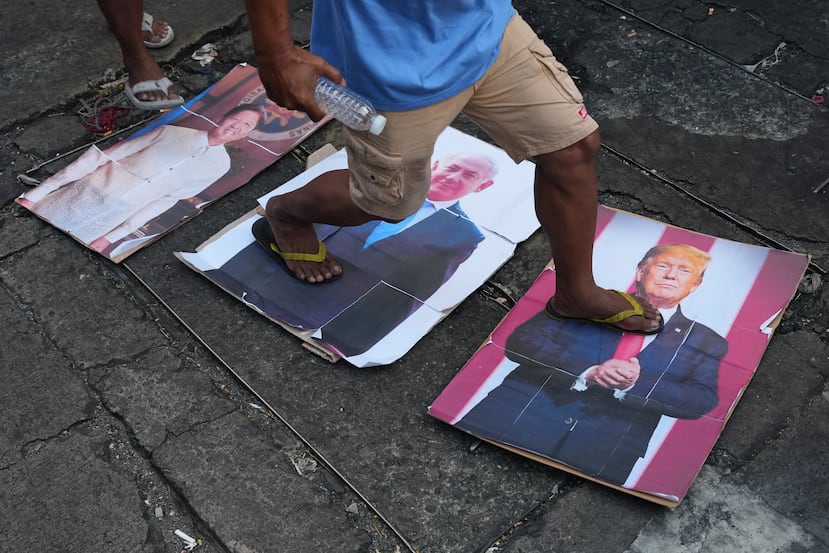 Jeepney drivers walk on portraits of U.S. President Donald Trump, Israeli Prime Minister Benjamin Netanyahu and Philippine President Ferdinand Marcos Jr. as they hold a rally during a strike of some transport groups to denounce the high prices of oil on Wednesday, April 15, 2026, in Manila, Philippines. (AP Photo/Aaron Favila)