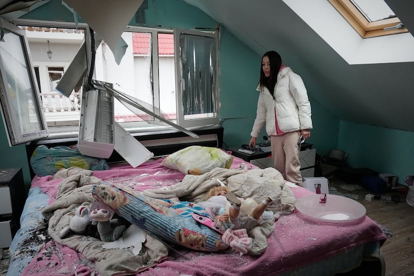 A woman looks at her damaged apartment after a Russian missile attack in Kyiv, Ukraine, Thursday, Oct. 22, 2026. (AP Photo/Efrem Lukatsky)