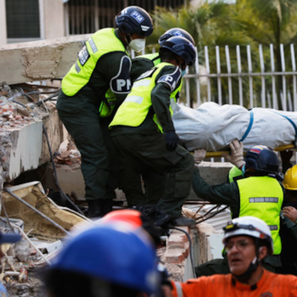 Los equipos de rescate transportan un cadáver rescatado de entre los escombros de un edificio derrumbado en Caracas, Venezuela.