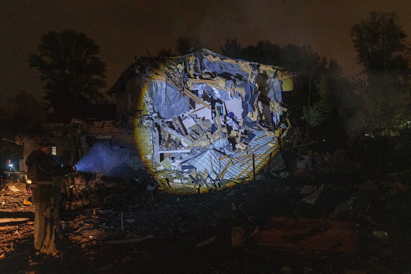 A man looks at residential house destroyed in a Russian missile strike on Kyiv, Ukraine, Wednesday, Oct. 21, 2026. (AP Photo/Evgeniy Maloletka)