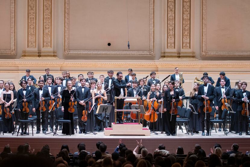 La Escuela Superior de Música Reina Sofía junto al director titular Andrés Orozco-Estrada (c), se presentan durante un concierto este jueves, en el Carnegie Hall en Nueva York (Estados Unidos). Más de setenta jóvenes músicos de la escuela, acompañados de quince miembros de la Filarmónica Joven de Colombia, interpretaron para el público el programa 'Viaje al Nuevo Mundo', que incluyó un total de tres piezas y un último bis con toque español. EFE/ Ángel Colmenares