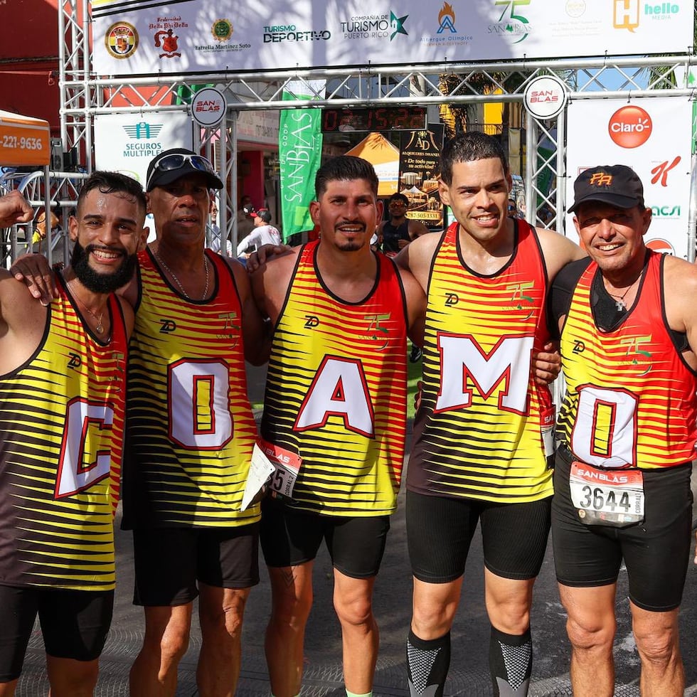 Corredores posan con las letras del municipio de Coamo.