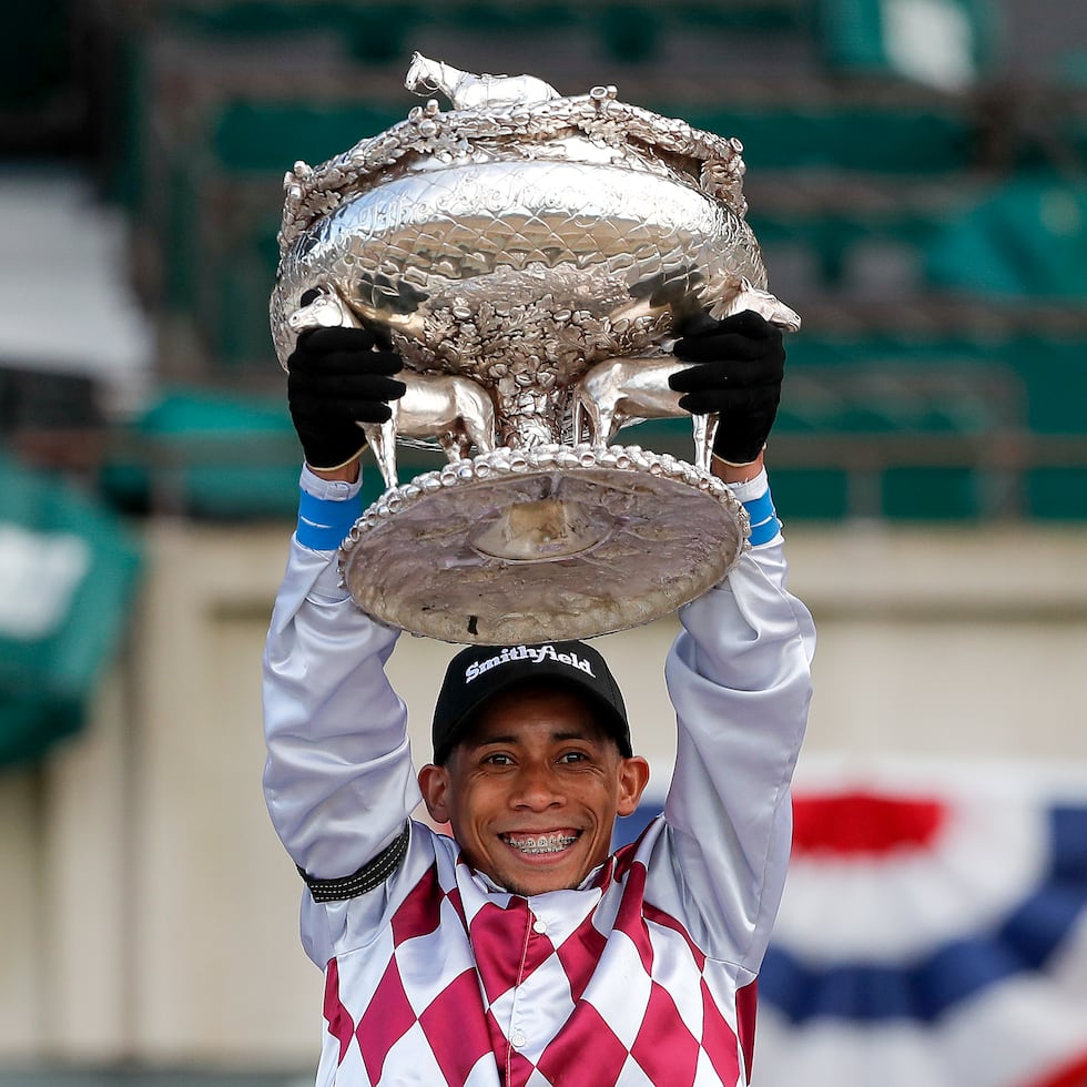 Jockey Manuel Franco holds up the August Belmont trophy after riding Tiz the Law to win the 152nd running of the Belmont Stakes horse race, Saturday, June 20, 2020, in Elmont, New York.