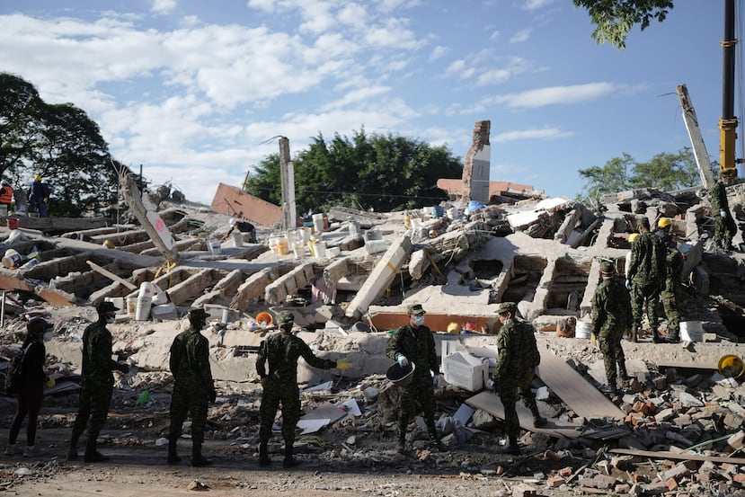 Soldiers clear debris three days after an earthquake struck Cali, Colombia, Thursday, Aug. 13, 2026. (AP Photo/Ivan Valencia)