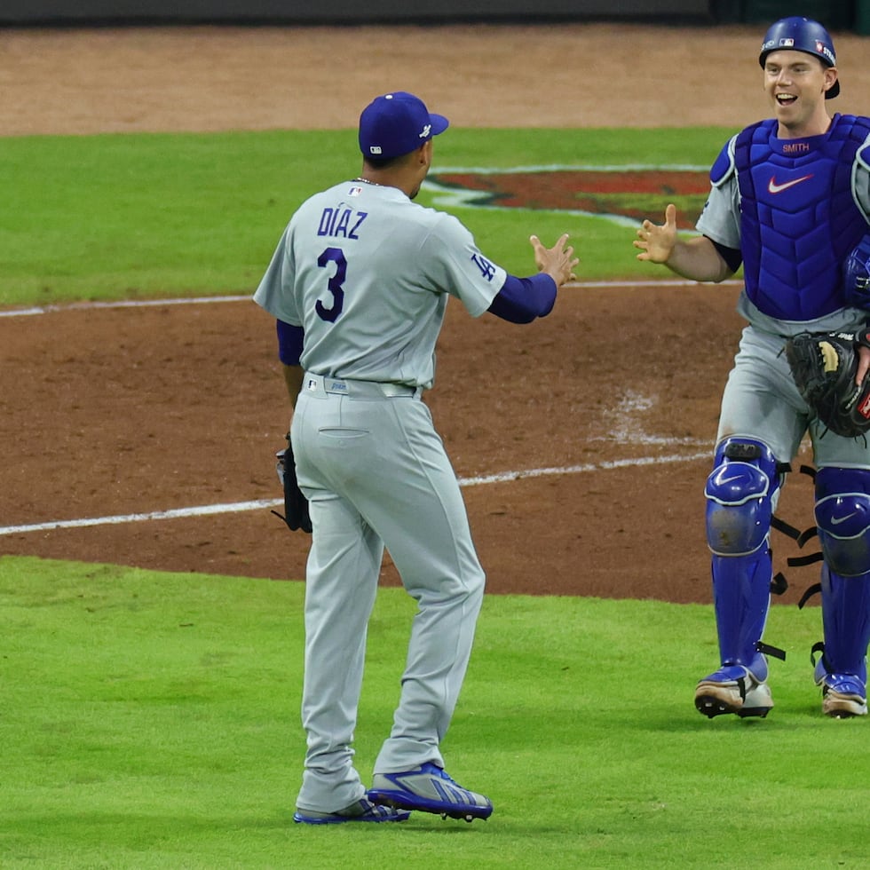 El receptor Will Smith se apresta a felicitar a Edwin Díaz (3) después de la victoria en el cuarto juego de la Serie Divisional de la Liga Nacional contra Atlanta.