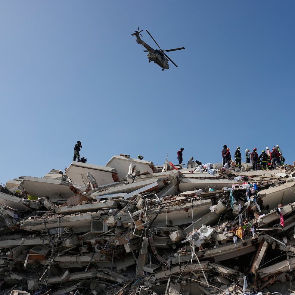 Rescue workers search through the rubble three days after earthquakes struck Catia la Mar, Venezuela, Saturday, June 27, 2026. (AP Photo/Fernando Vergara)