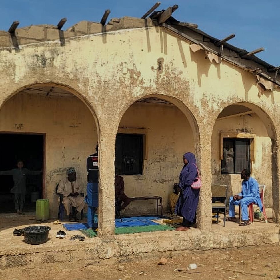 Los dolientes se reúnen en la casa de Hassan Yakubu Makuku, subdirector de la Escuela Secundaria Pública para Chicas, donde ayer hombres armados secuestraron a 25 niñas y lo mataron, en Kebbi, Nigeria.