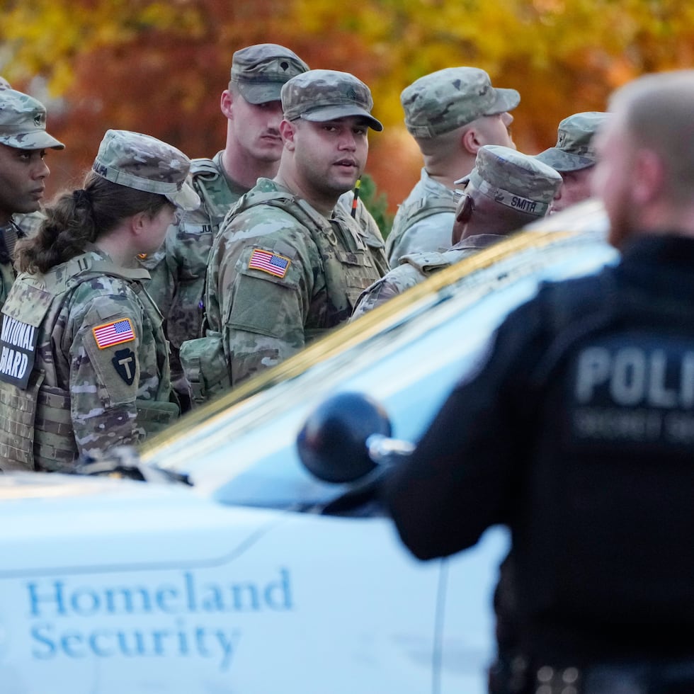 Members of the National Guard gather after reports of two National Guard soldiers were shot near the White House in Washington, Wednesday, Nov. 26, 2025. (AP Photo/Mark Schiefelbein)