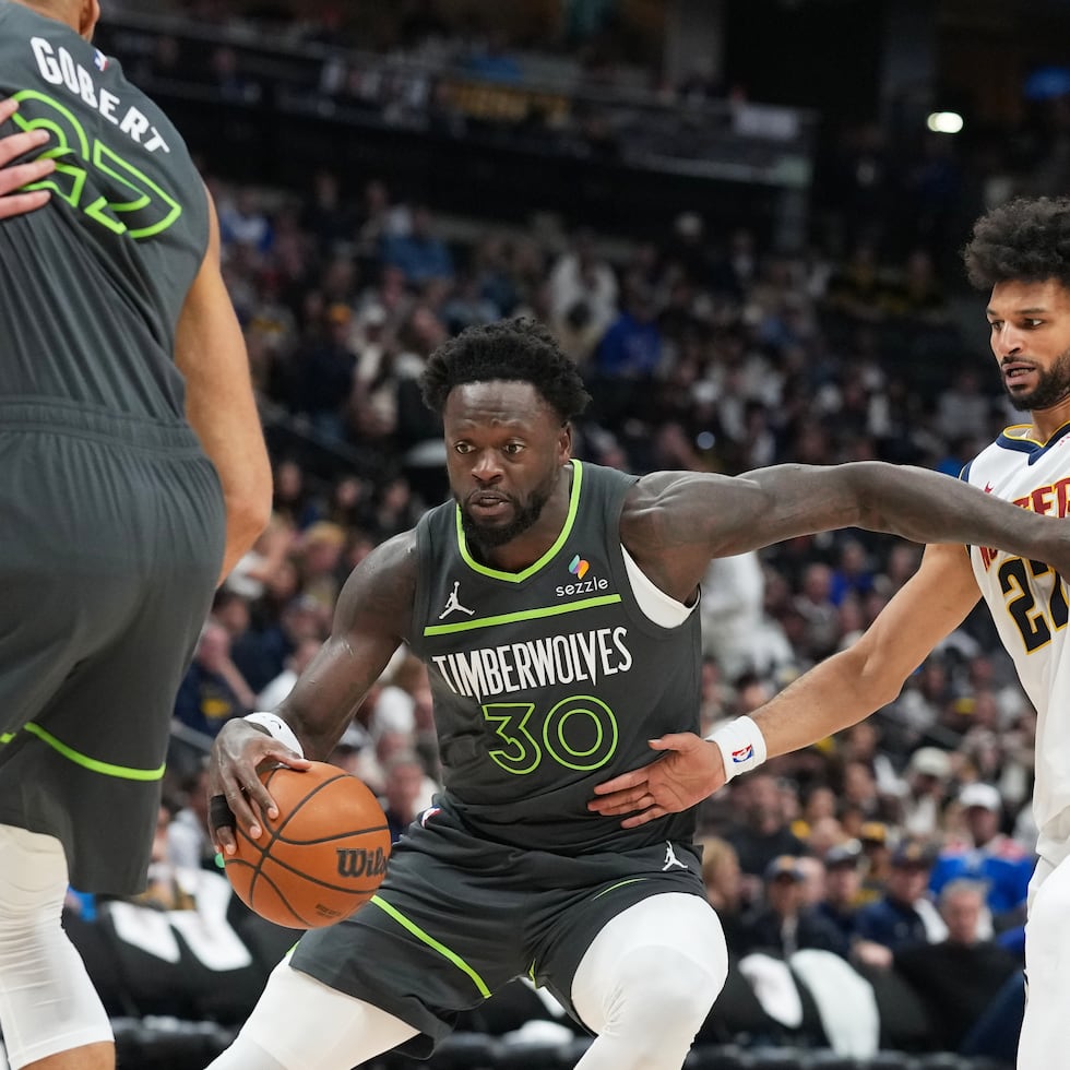El alero de los Minnesota Timberwolves, Julius Randle (izquierda), supera al base de los Denver Nuggets, Jamal Murray, en la segunda mitad del primer partido de la primera ronda de los playoffs de la NBA, el sábado 18 de abril de 2026, en Denver.
