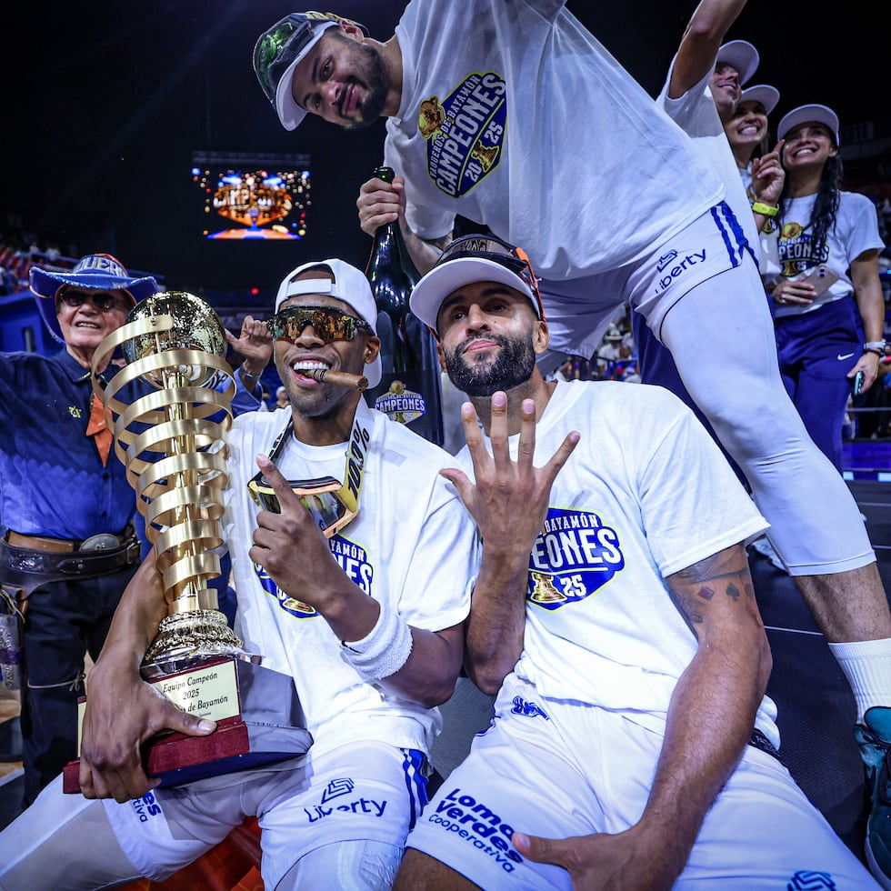 Gary Browne, Javier Mojica y Luis "Pelacoco" Hernández celebran con el campeonato del BSN tras el triunfo de los Vaqueros de Bayamón sobre los Leones de Ponce el pasado verano.