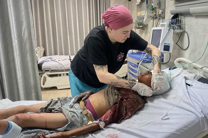 This photo provided by American nurse Andee Vaughan, shows Vaughan attending to a wounded child at the Al-Quds Hospital in Gaza City on Aug. 10, 2025. (Courtesy Andee Vaughan via AP)