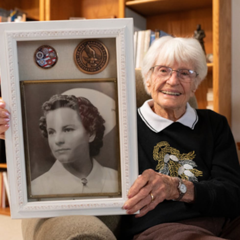 Alice Darrow shows a photo of herself from when she was a nurse during World War II, Thursday, Oct. 23, 2025, at her home in Danville, Calif. (AP Photo/Laure Andrillon)