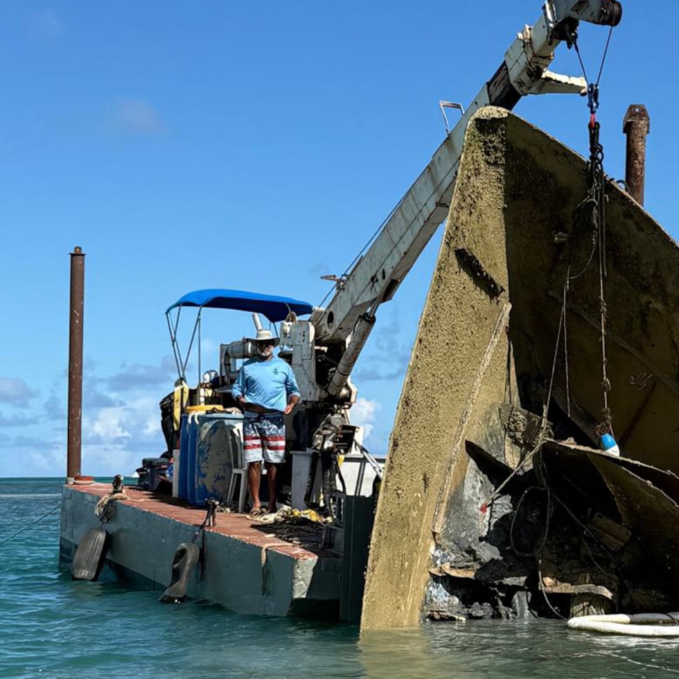 Specialized personnel work to remove a sunk vessel.