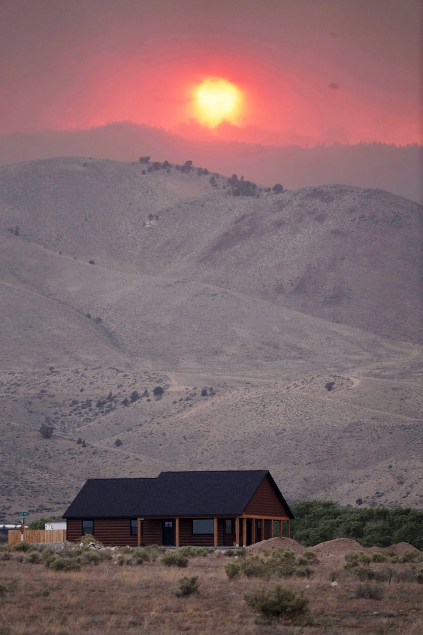 The sun sets over the Cottonwood Fire near Marysvale, Utah, on Friday, June 26, 2026. (AP Photo/Ty ONeil)