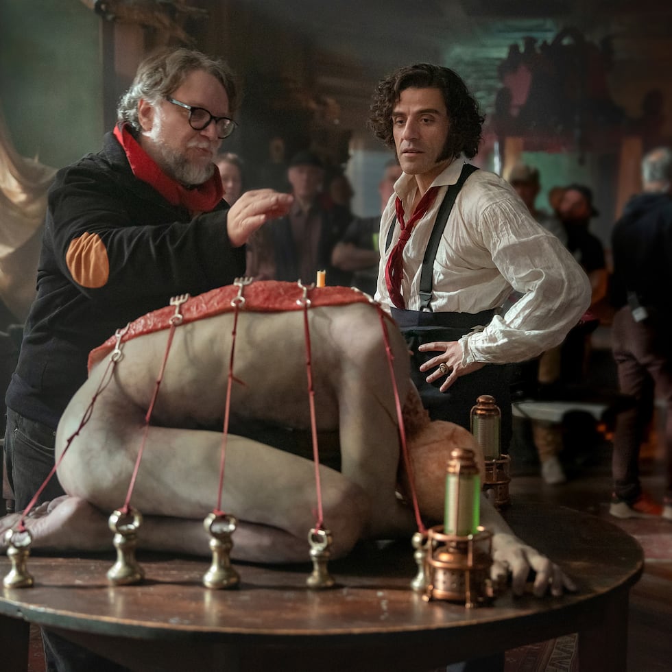 This image released by Netflix shows director Guillermo del Toro, left, and Oscar Isaac on the set of "Frankenstein." (Ken Woroner/Netflix via AP)