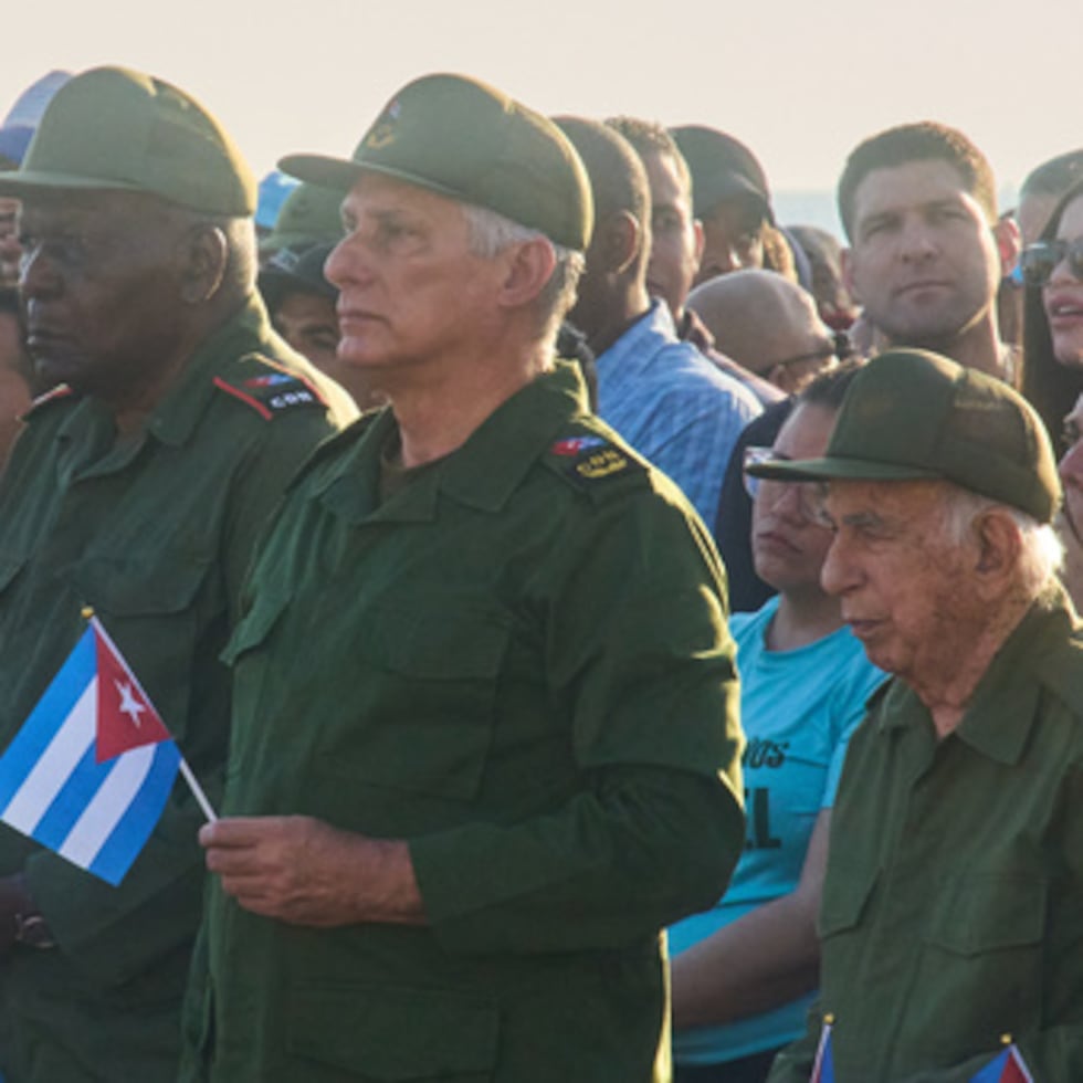 El presidente de Cuba, Miguel Díaz-Canel, segundo a la izquierda, y el nieto de Raúl Castro, Raúl Guillermo Rodríguez Castro, en el centro, participan en una concentración de apoyo al expresidente Raúl Castro frente a la embajada de Estados Unidos en La Habana, Cuba