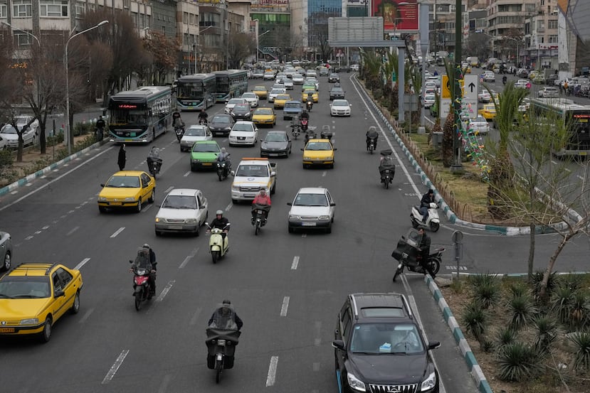 Vehicles drive in downtown Tehran, Iran, Tuesday, Feb. 24, 2026. (AP Photo/Vahid Salemi)