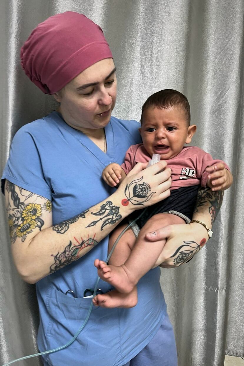 In this photo provided by American nurse Andee Vaughan, she holds a boy with a respiratory illness at Al-Quds hospital in Gaza City on July 27, 2025. (Courtesy Andee Vaughan via AP)