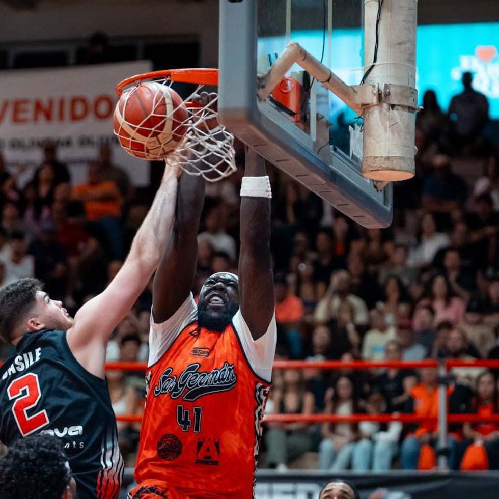 Montrezl Harrell, de los Atléticos, donquea el balón contra Grant Basile, de los Piratas.