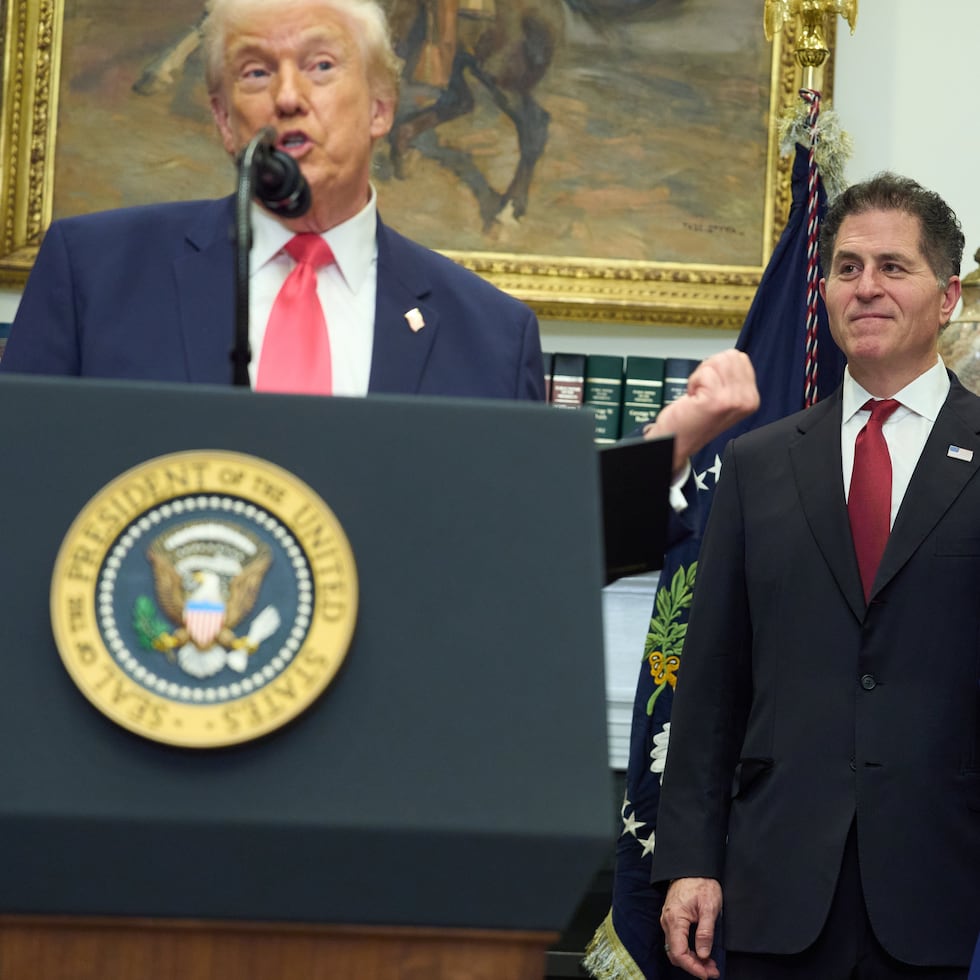 Michael Dell and his wife Susan listen to President Donald Trump.