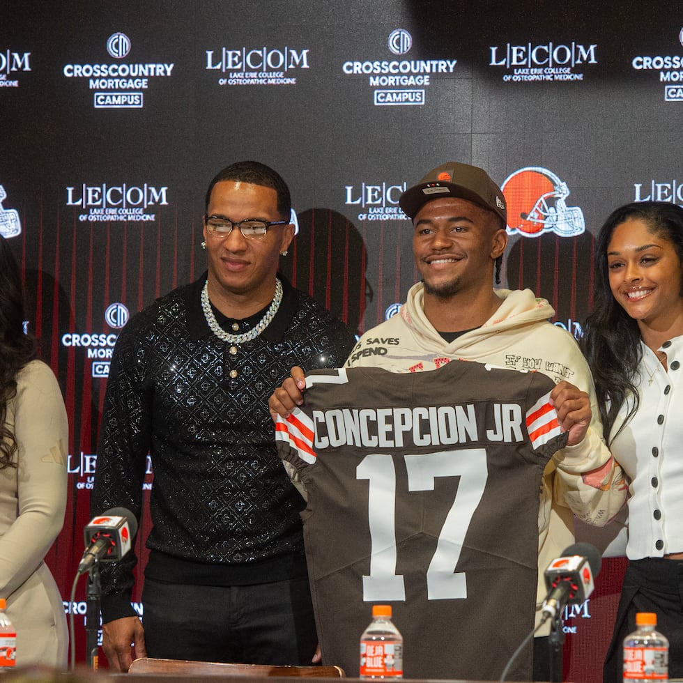 Cleveland Browns first-round draft choice KC Concepcion, center right, holds his team jersey with his family and girlfriend Lemyah Hylton, right, father Kevin, center left, and mom Aerial.