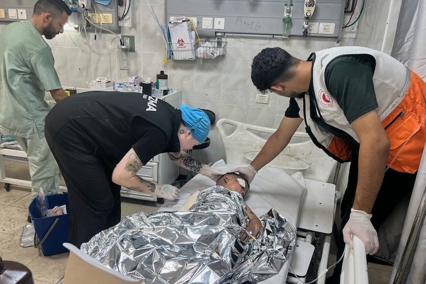 This photo provided by American nurse Andee Vaughan, second from left, shows Vaughan attending to a child suffering from severe burns after an Israeli army strike on his house, at the Al-Quds Hospital in Gaza City on July 24, 2025. (Courtesy Andee Vaughan via AP)