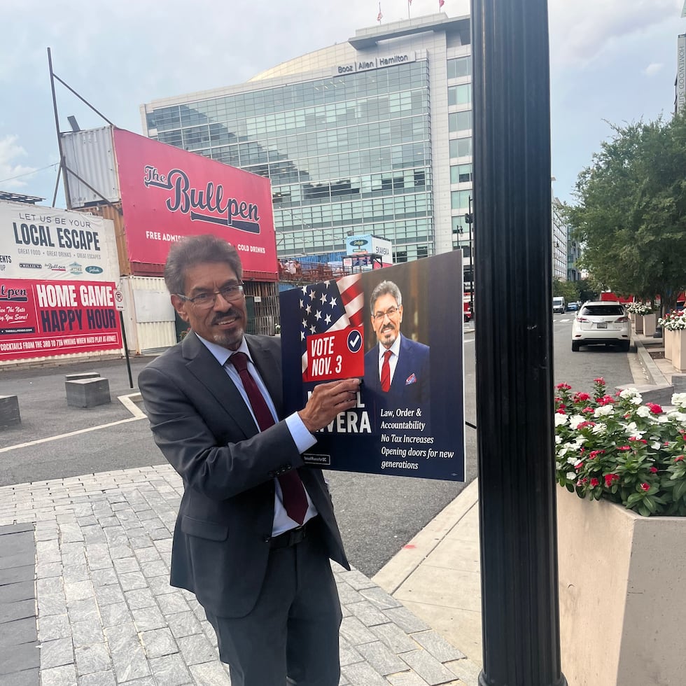 Manuel Rivera, the Republican candidate for attorney general of Washington, D.C., puts up a campaign sign ahead of the local elections on November 3.