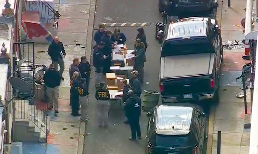 FBI agents are outside a building after a raid in the Kensington section of Philadelphia on Friday, Oct. 24, 2025. (WPVI via AP)